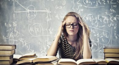 Beautiful blonde girl stressed by the study