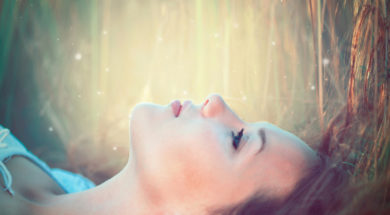 Beauty Romantic Girl lying on the Field and dreaming. Beautiful