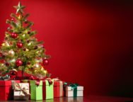 Christmas tree with gifts on red background.