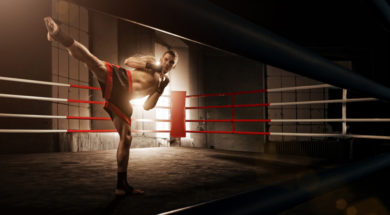 Young man kickboxing in the Arena