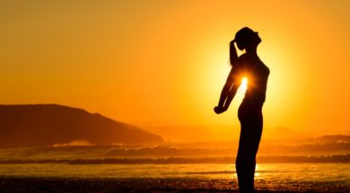 Relaxing Exercises On Beach At Sunset