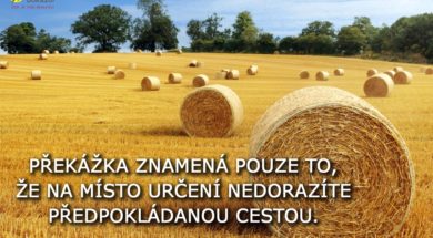 Hay bail harvesting in golden field landscape