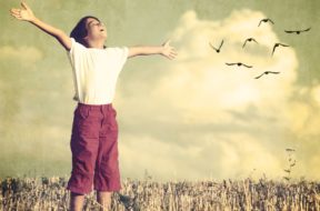 Colorized kid breathing fresh air with birds flock flying in bac