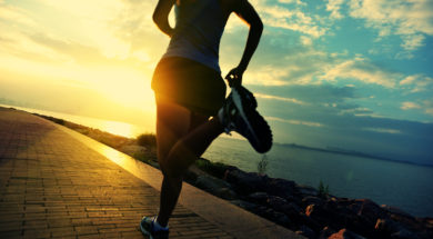 Runner athlete running at seaside. woman fitness silhouette sunr